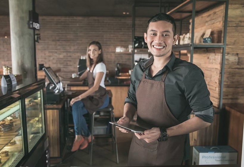 Smiling cafe owners behind the counter