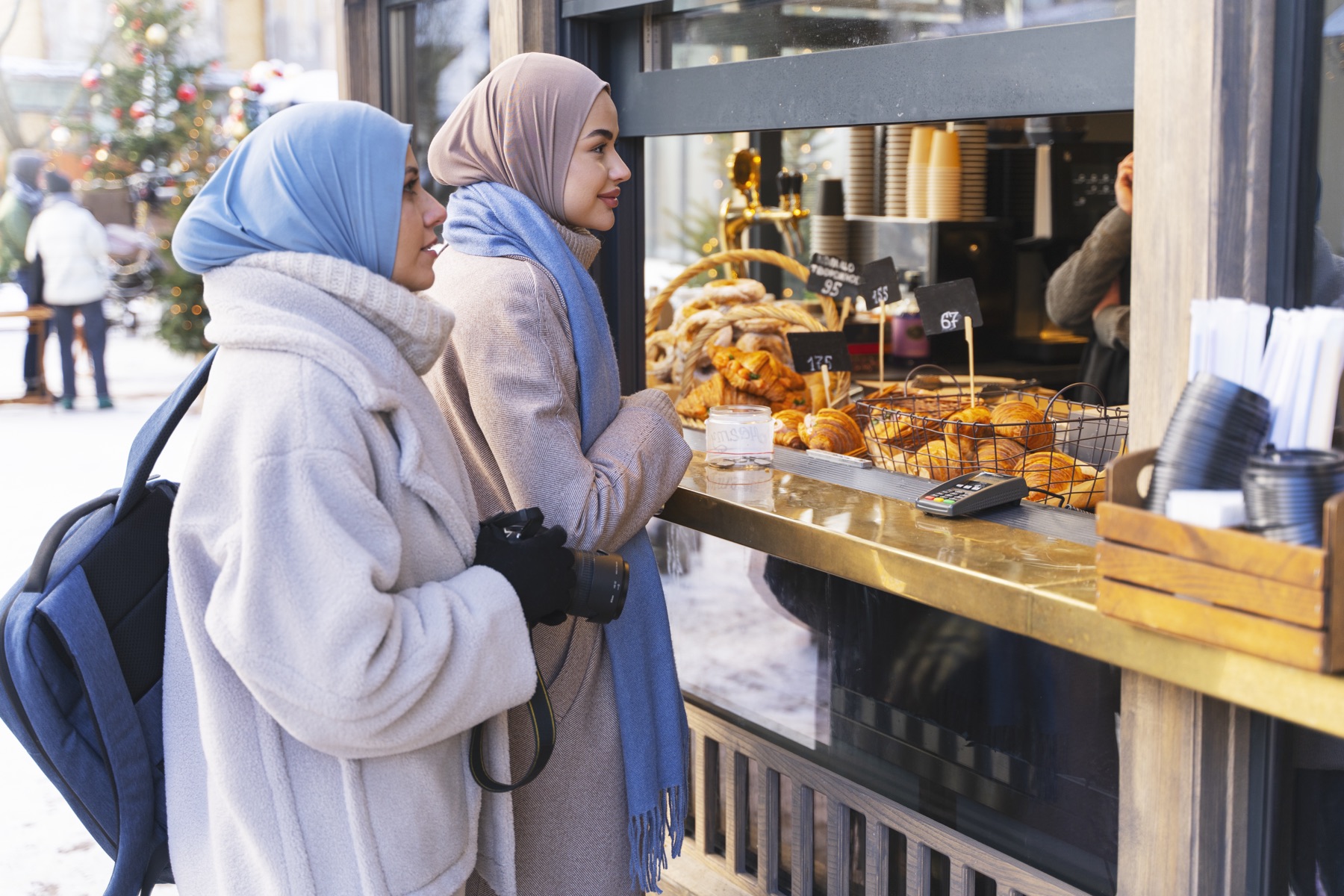 Two women buying pastries at a grab and go counter